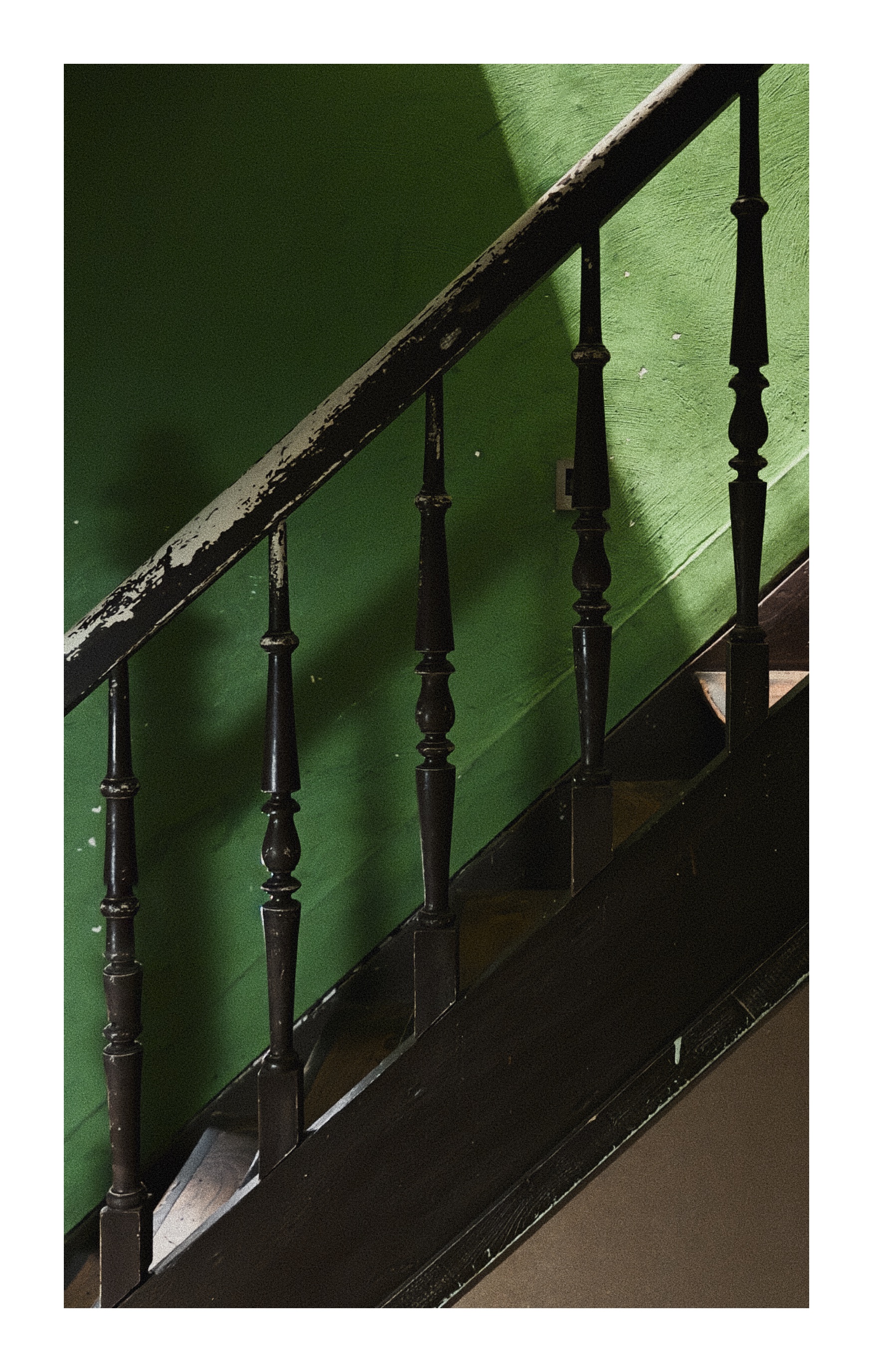 Old wooden staircase with green wall